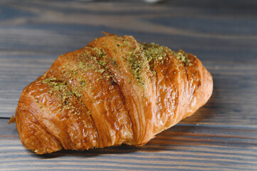 fresh baked croissant isolated on a wooden background