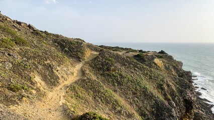 Rugged coastal trail whispers ancient tales of maritime wanderers, perfect for wind-swept Solstice...