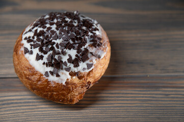 Sweet cinnamon bun roll swirl on a wooden background