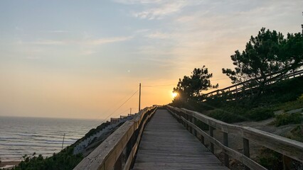 Pathway whispers nostalgia at sunset, evocative of Solstice celebrations and contemplative seaside...