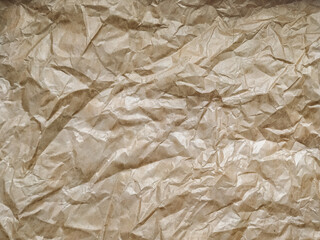 Vintage background made of heavily wrinkled paper used as wrapping paper. Texture of tracing paper made from recycled materials.