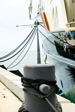 Close up view of bollard and yacht moored at wharf
