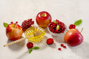 Rosh Hashanah, the Jewish New Year. Traditional symbols are apples, pomegranate and honey on a...