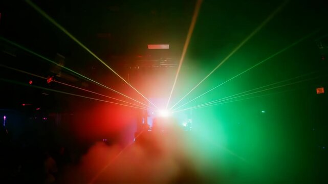 Vibrant laser lights cutting through colorful smoke, dynamic beams illuminating foggy nightclub or concert space with intense energy and no visible people