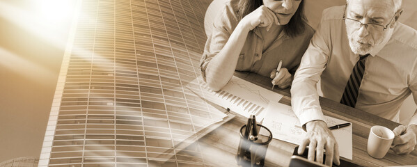 Two mature business people working together; multiple exposure