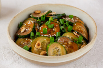 Cucumber salad with sesame seeds, green onion, soy sauce and garlic, trendy food.