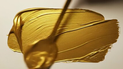 Luxurious thick gold metallic paint creating a rich texture with spread strokes, ideal for abstract backgrounds and shiny elegant designs. - Powered by Adobe