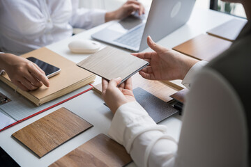 Interior designer presenting eco friendly wooden material samples for sustainable home decor