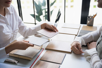 Interior designer presenting eco friendly wooden material samples for sustainable home decor