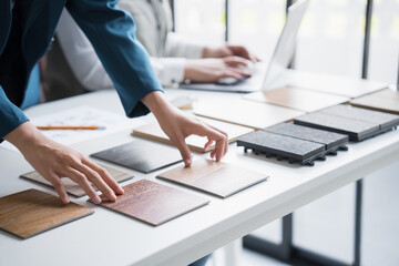 Interior designers brainstorming creative design ideas for modern home in collaborative meetingใ