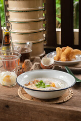 Rice porridge or pork congee for breakfast, boiled eggs, fried dough sticks, traditional coffee, soft-boiled eggs