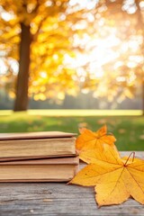 Two vintage books rest on a wooden surface beside vibrant autumn leaves, with a sunlit forest glowing warmly in the background.