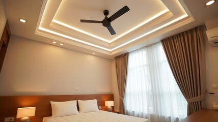 Interior view of a bedroom with a ceiling fan, bed, curtains, and recessed lighting design elements