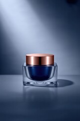 Close up of a square glass jar with a copper lid filled with blue cream on a blue background
