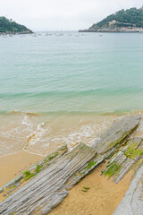 Serene Beach and Rock Formation in San Sebastian, Spain