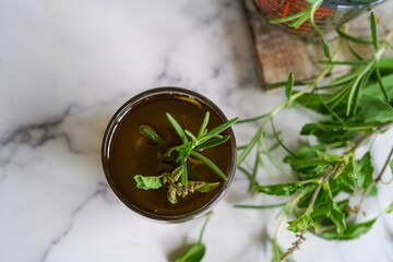 Homemade rosemary tulsi oil for hair growth, selective focus