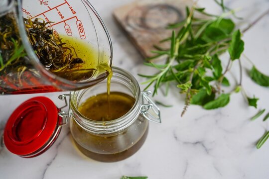 Homemade rosemary tulsi oil for hair growth, selective focus