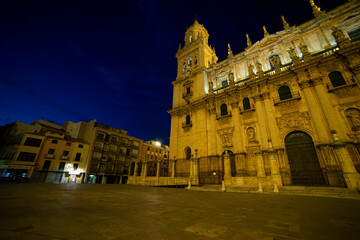 Stunning view of Catedral de Jaen illuminated at night against a deep blue sky in Andalucia, Spain