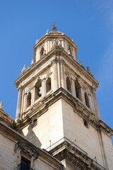 Majestic bell tower of Santa Iglesia Catedral in Jaen, Andalucia, showcases stunning architecture against a clear blue sky