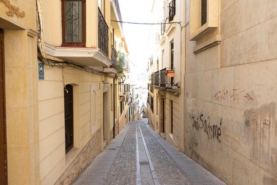 Exploring the narrow streets leading to Santa Iglesia Catedral in Jaen, Andalucia, Spain on a bright sunny day