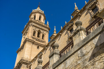 Fototapeta premium Exploration of Santa Iglesia Catedral with its Stunning Tower in Jaen, Andalucia Under a Clear Blue Sky