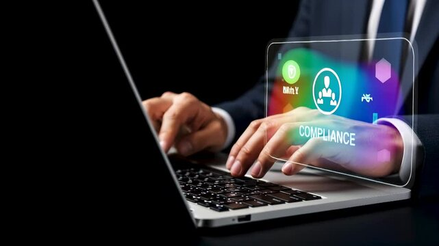 Close-up of businessman working on laptop with holographic compliance icon, representing business regulation, legal standard, law, and corporate policy enforcement through digital solution.