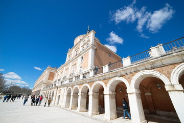 Fototapeta premium Visitors enjoy the architectural beauty of the Royal Palace in Aranjuez, Spain on a clear day