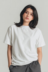 Fototapeta premium A beautiful female model wearing a white t-shirt. A product shot for fashion and apparel. best use for mockup.