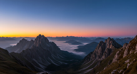 Stunning peak view of a mountain range at sunrise. Fog covered valley with a vibrant horizon. Outdoor travel and adventure concept.