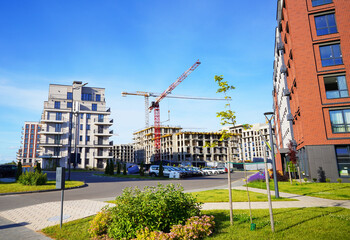 New residential building after construction. Modern Residential condo complex. Tower crane on...