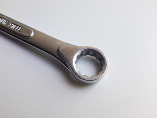 A ring spanner, also known as a combination wrench, isolated on a white background.