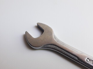 A ring spanner, also known as a combination wrench, isolated on a white background.