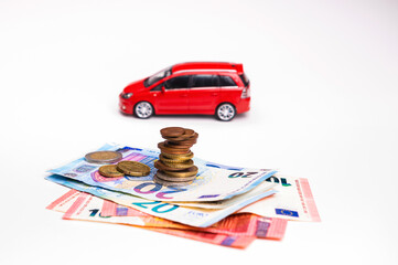 euro cash and toy vehicle isolated on white, money  for car loan payment and insurance concept
