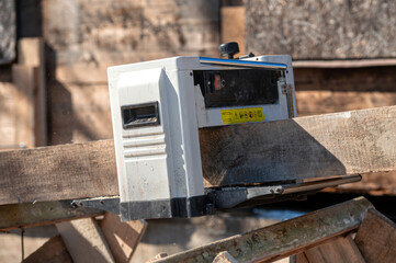 Woodworking tool in use at a construction site during a sunny day