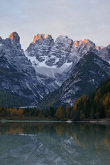 mountain landscape with lake at sunrise in the dolomites