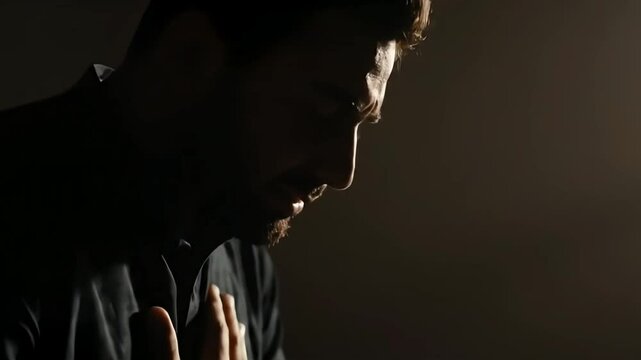 A poignant and contemplative video showcasing a man engaged in heartfelt prayer