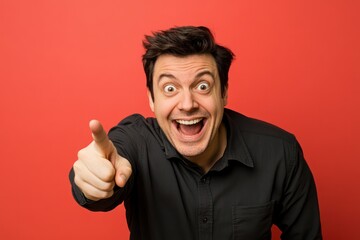 Smiling man pointing forward with excitement