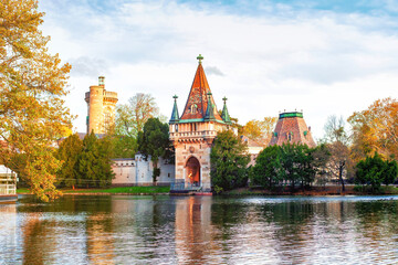 Naklejka premium Medieval Franzensburg castle on lake in colorful autumn Laxenburg park, Lower Austria