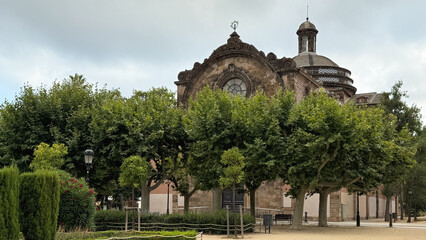 Charming Historical Building Surrounded by Lush Trees in a Serene Park Setting in Barcelona, Spain