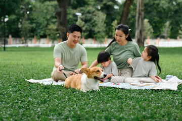 Young Family Enjoying a Relaxing Picnic with Children and Dog in the Park