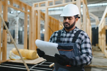 Indian carpenter works on the construction of modular houses