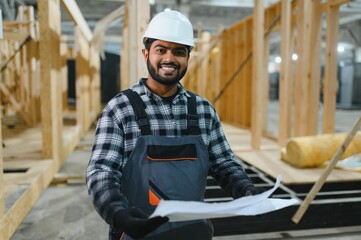 Indian carpenter works on the construction of modular houses