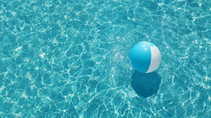 Colorful beach ball floating in clear blue pool water  