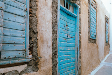 Rustic weathered blue wooden door on Milos island, Greece