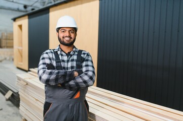 Indian carpenter works on the construction of modular houses