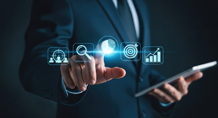 A businessman holding a tablet points at digital icons representing business strategy, goals, data analysis, and growth charts, symbolizing strategic planning and success