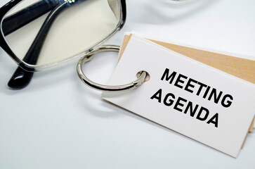 Meeting Agenda with keyring on white notepad.