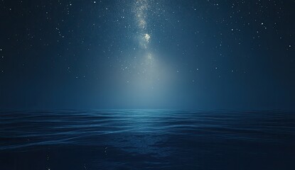 Night sky over a dark, rippled ocean.  Stars and a milky way streak across a deep blue night.  Calm, reflective water surface
