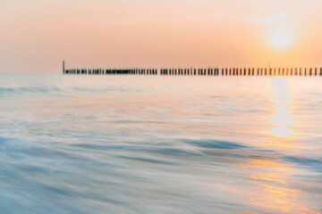 Golden sunset illuminates the calm coast of Walcheren near Domburg.