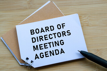 Board Of Directors Agenda on wooden table with pen